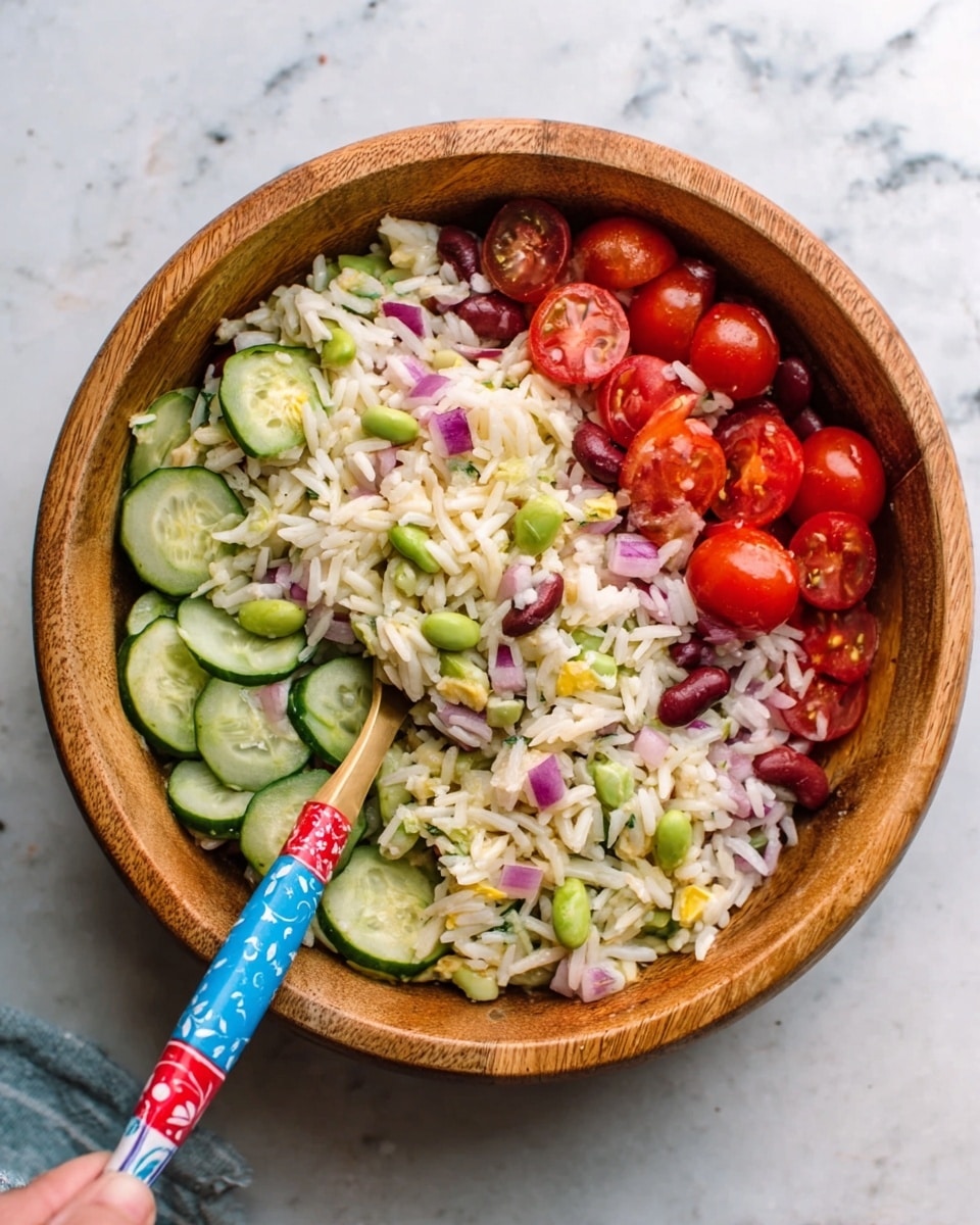A wooden bowl filled with a colorful rice salad. The salad has three main layers: the bottom layer is white rice mixed with small green peas and kidney beans, the middle layer shows slices of light green cucumber and chopped red onions scattered evenly, and the top layer is dotted with halved bright red cherry tomatoes. A woman's hand holds a colorful fork with a blue and red patterned handle resting inside the bowl. The bowl is placed on a white marbled surface. photo taken with an iphone --ar 4:5 --v 7
