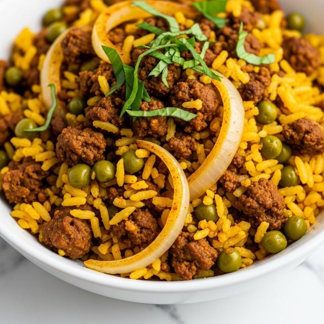 A close-up of a white bowl filled with cooked yellow rice mixed with green peas, browned ground meat, and translucent cooked onion slices, all seasoned with spices giving an orange-yellow tint; fresh green herb leaves are scattered on top, adding a fresh touch, the bowl is placed on a white marbled surface photo taken with an iphone --ar 4:5 --v 7
