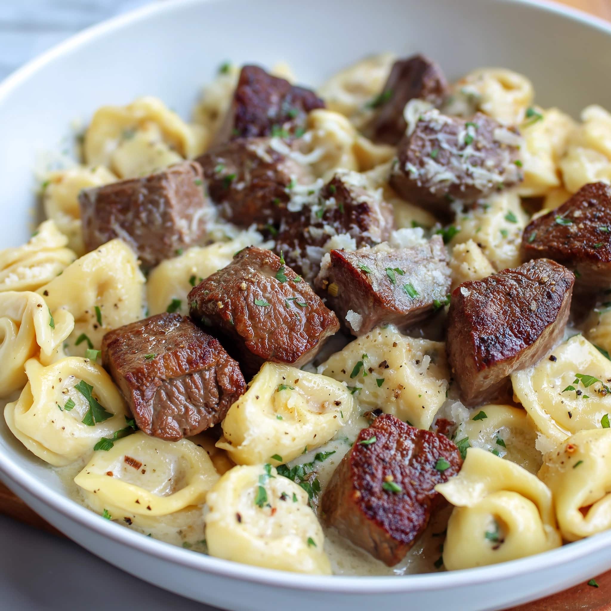 Steak Bites and Shell Pasta in Garlic Butter Alfredo Recipe - Recipe Image